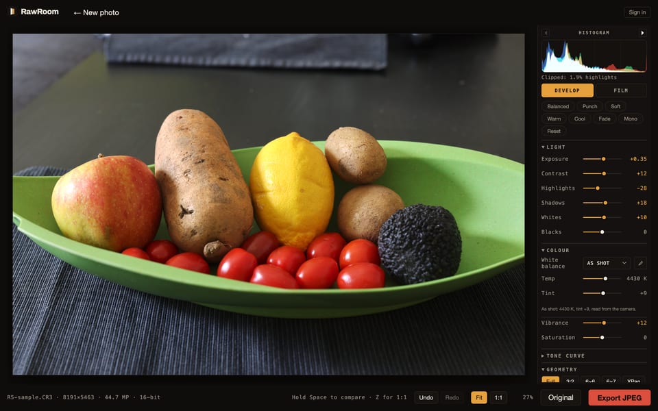 The RawRoom editor at desktop width with the Develop tab open, the live histogram above the tool rail, and the export key at the right of the control bar.