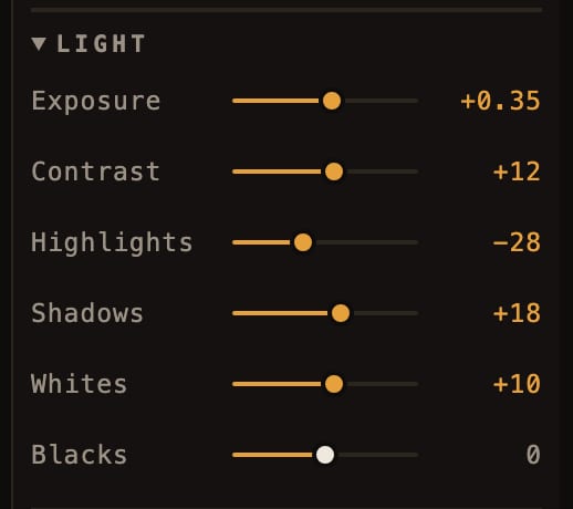 A close crop of the Light section of the tool rail: exposure, contrast, highlights, shadows, whites and blacks, with the moved rows reading amber.